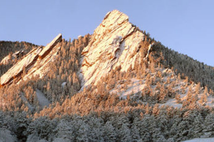 Large rock outcropping with dusting of snow.