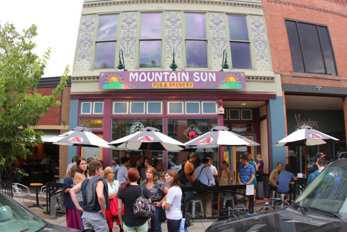 Entrance to brewery with umbrella tables out front.
